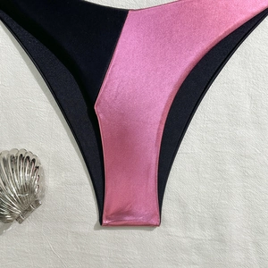 Detailed close-up of pink and black split splicing bikini bottom with shell decor