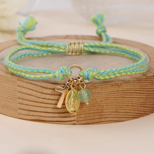 Handwoven green cord bracelet with gold cross, Madonna pendant and green jade bead