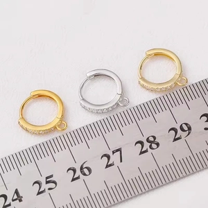 Close-up of 1.5cm cubic zirconia earring hooks in gold and silver finishes with ruler