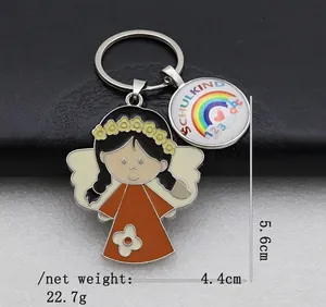 Detailed view of angel keychain with rainbow charm featuring Schulkind 123 abc text