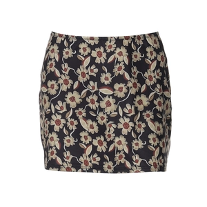 Flat lay of a floral print high-waist mini skirt with beige flowers on a dark base