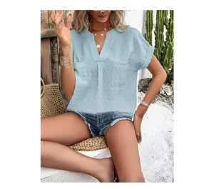 Detail of light blue Swiss dot fabric texture on casual short sleeve V-neck shirt