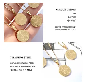 Macro shot of 18K gold plated justice scales pendant and fine titanium steel chain link