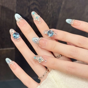 Blue gradient press-on nails with luxury crystals and silver French tips on long almond shape