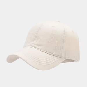 Close-up of distressed vintage baseball cap detail with white stitching and frayed edges