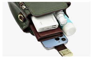Macro view of green bucket bag interior capacity showing everyday essentials and metal clasp