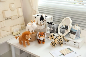 Collection of six mini plush animals including lion and tiger in a cozy home setting