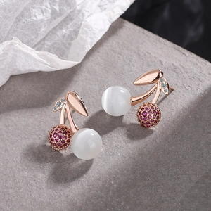 Rose gold cherry earrings with white cat eye stone and red cubic zirconia gems