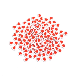 Macro shot of 8mm white acrylic heart beads with red patterns for DIY jewelry making