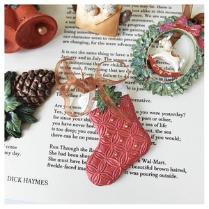Detail of vintage Christmas stocking ornament with gold beads on artistic paper background