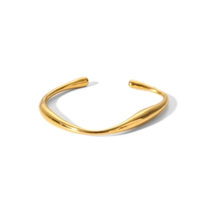 Close-up of golden irregular streamline cuff bracelet with high-gloss metallic finish
