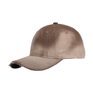 Close-up of distressed brim with worn holes on a vintage washed tie-dye baseball cap