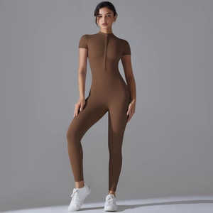 Detail of slim-fit athletic jumpsuit with front zipper and short sleeves in dark brown