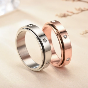 Polished titanium steel spinning rings with sparkling zircons in silver and rose gold finishes
