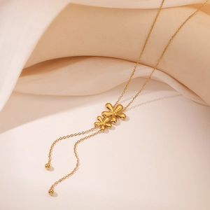 Golden flower heart pendant necklace with elegant Y-shape drop design on soft fabric