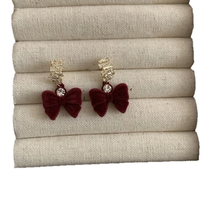 Boucles d'oreilles nœud en velours rouge dorées à l'or fin avec strass étincelants