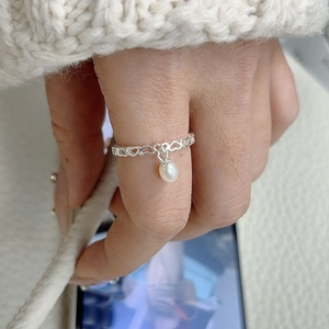 Elegant S925 sterling silver hollow heart ring featuring a dangling white pearl charm