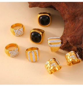 Detailed view of eight gold plated titanium rings with black agate and micro-set diamonds