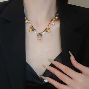 Close-up of luxury necklace set with colorful zircon flower leaves on a female model