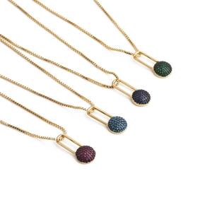 Close-up of four gold necklaces with vibrant green, blue, and pink zircon lock pendants