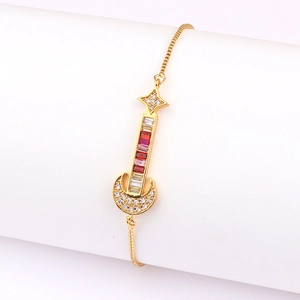 Detail view of a gold guitar and moon bracelet charm with colorful cubic zirconia stones