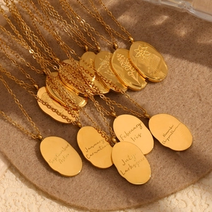 Golden oval pendant necklaces with monthly flower engravings and delicate chains