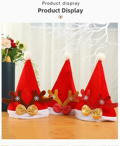 Detailed view of three red velvet Christmas hats with sequined antlers and white fur trim