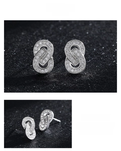 Macro shot of silver S925 earrings with interlocking rings and pavé zircon stones
