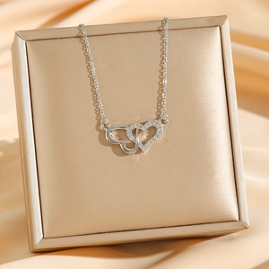 Elegant silver interlocking double heart necklace with pavé zircon on gift box