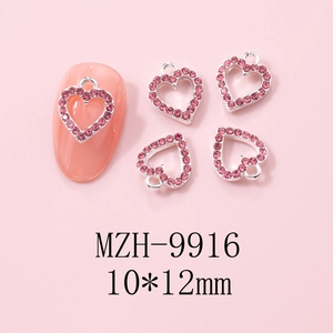 Detail of Y2K hollow heart nail charms with pink rhinestones for Valentine manicure