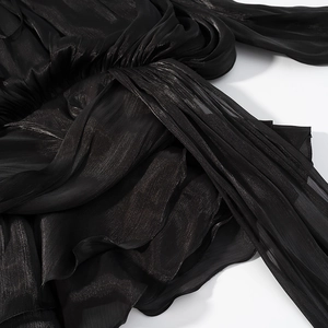 Vue détaillée de la taille de robe noire avec plis élégants et texture de tissu nouée