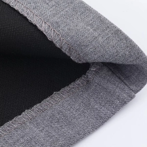 Close-up of grey knitted fabric with black lining showing lockstitch sewing craft detail