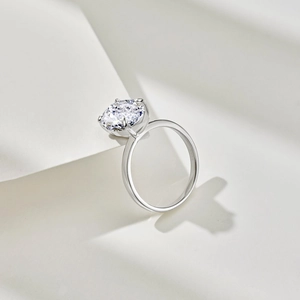 Macro detail of oval cut ice flower cubic zirconia stone in a 4-claw silver ring setting