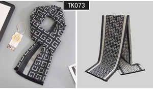 Close-up of premium cashmere scarf showing double-sided grey geometric jacquard and fringe