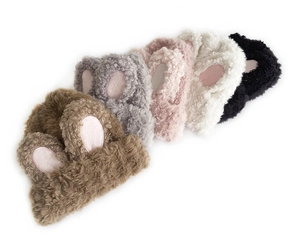 Detail of five fluffy bunny ear beanies in various colors showing thick plush texture
