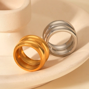 Macro view of minimalist double-layered stainless steel rings in gold and silver