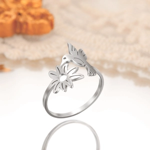 Polished silver hummingbird and flower open ring with an elegant reflective finish