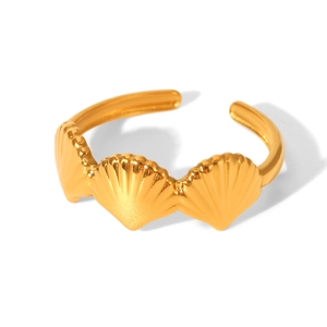 Macro detail of three golden shells on a polished stainless steel adjustable ring