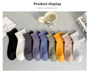 Flat lay of nine colorful ribbed cotton mesh socks for men in various solid colors