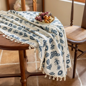 Close-up of blue floral cotton linen tablecloth with delicate tassel edge detail
