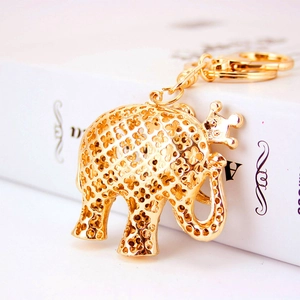 Golden elephant keychain with crown and clover hollow design for bags and cars