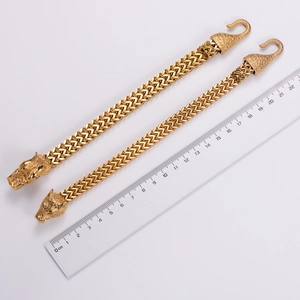 Detailed view of gold Viking wolf head double chain bracelet with measurement scale