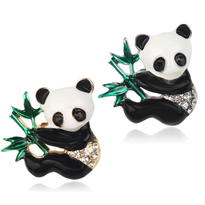 Close-up of cute panda stud earrings with black and white enamel and green bamboo