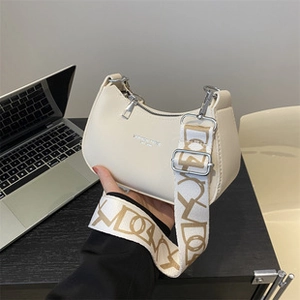 Beige PU leather crossbody bag with CD letter print wide strap shown on a desk