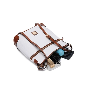 Detail showing the spacious interior of white pebble grain crossbody bag with daily essentials