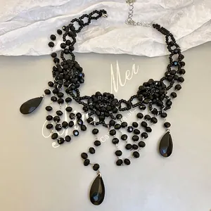 Gothic multilayered black beaded collar necklace with flower accents and waterdrop pendants