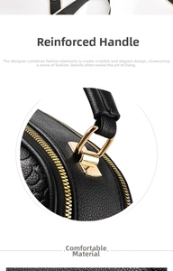 Detail of reinforced black pebbled leather handle with gold metallic hardware accents