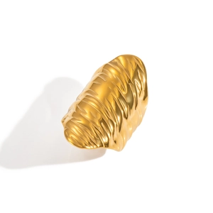 Macro shot of gold textured ring with unique pleated metal surface and minimalist design