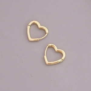 Detailed view of heart-shaped gold hoop earrings with a polished metallic finish