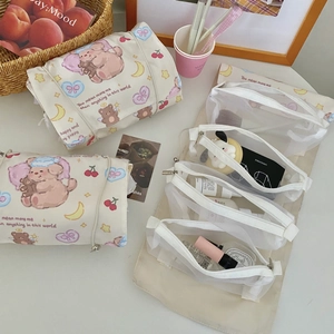 Close-up of detachable mesh compartments in star puppy patterned travel makeup bag